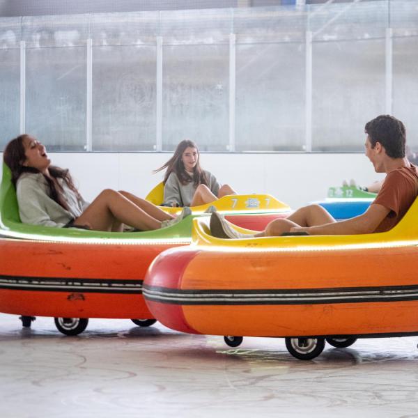 Students ride bumper cars on the Rec Center ice rink