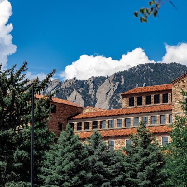 campus building with Flatirons in the background