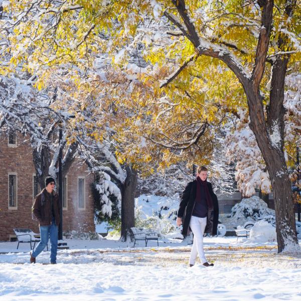 Students walk on a snowy campus