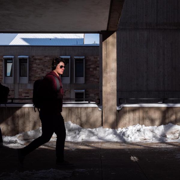 Student walking on a snowy campus
