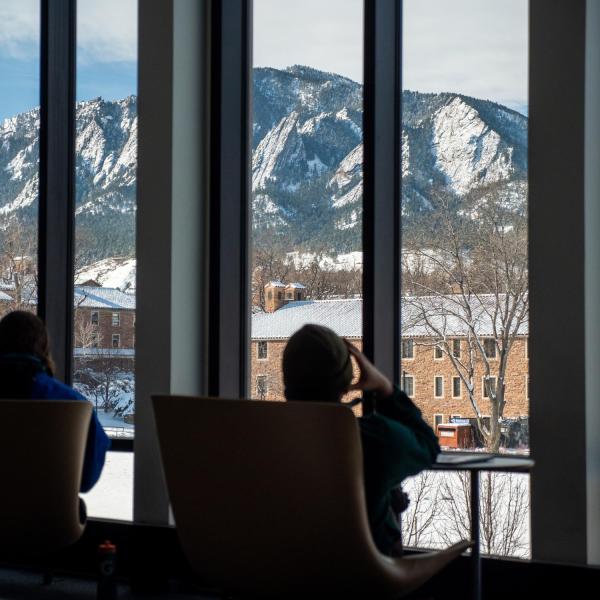 Students looking out at a snowy campus