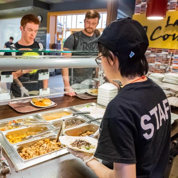 student employee interacting with a campus community member