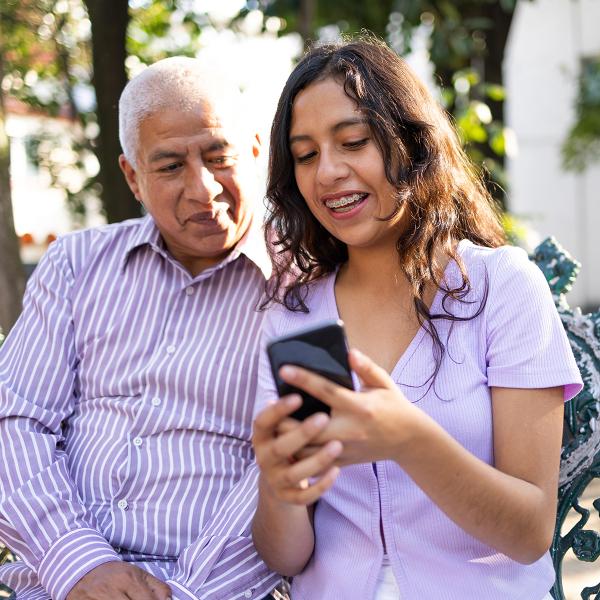 Two people checking a phone alert