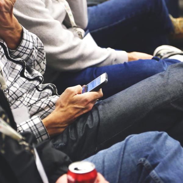 People sitting and checking mobile phones