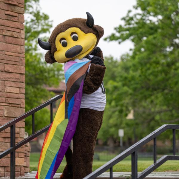 Chip holding an LGBTQ pride flag