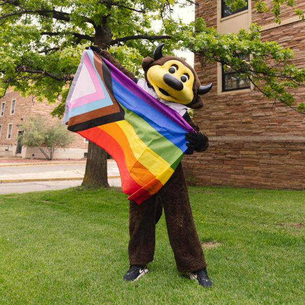 Chip holding an LGBTQ+ pride flag