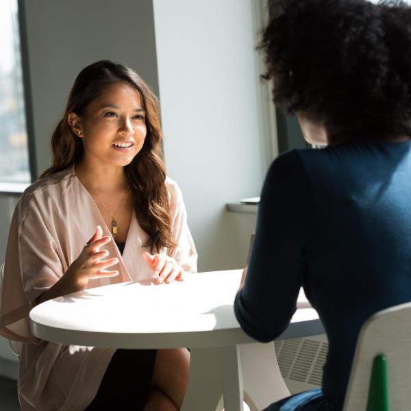 two people talking at a table