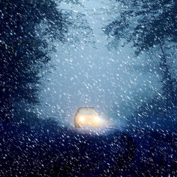 Car driving through snow storm