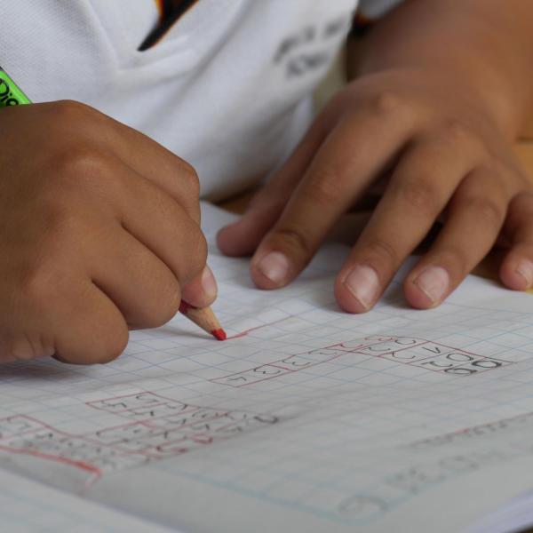 A child's hands as he or she does homework