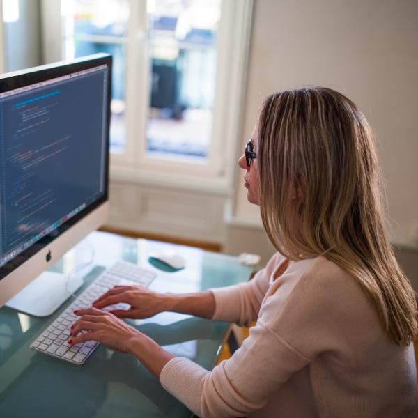 Female programmer writing code
