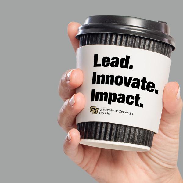 Disposable coffee cup that says 'Lead. Innovate. Impact.'