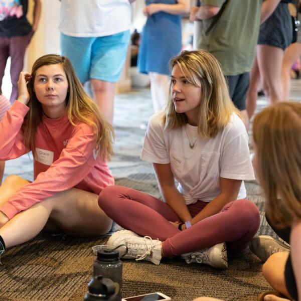 Students sit in a circle