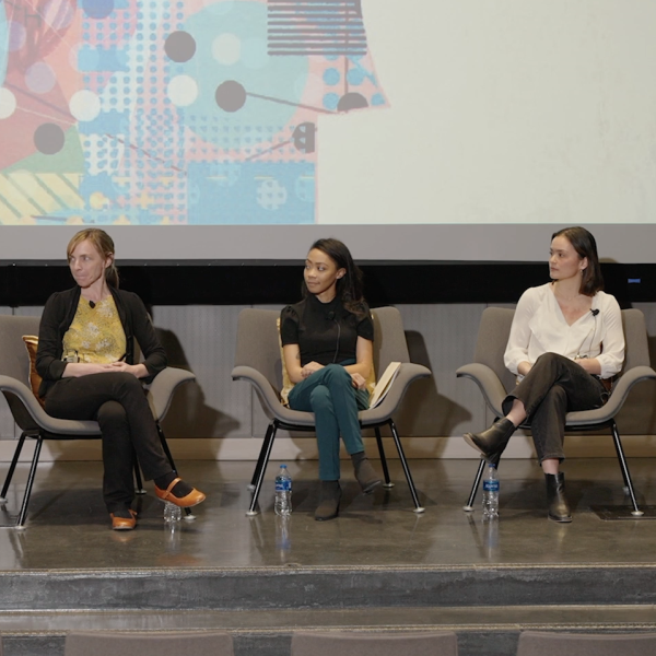 Featured speakers sit in a panel to take questions