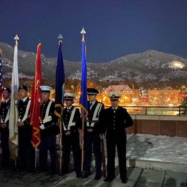 A ceremony with the Boulder star in the background