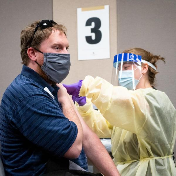 A person receiving a COVID-19 vaccination at SEEC