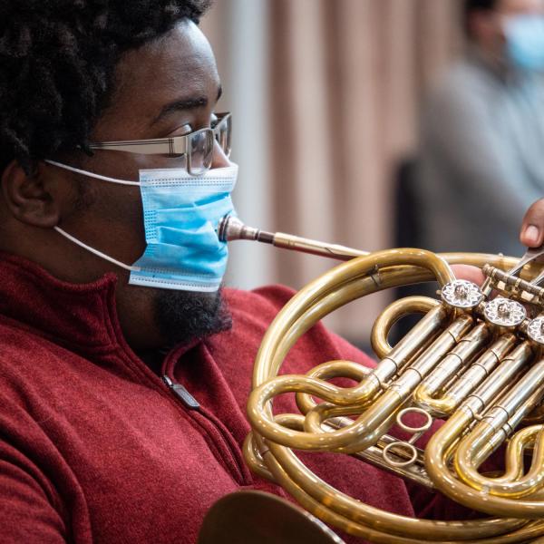 Playing French horn with a mask