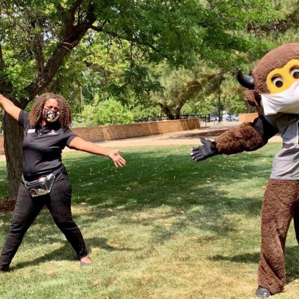 Crystal Lay poses for a photo with Chip the costumed mascot.