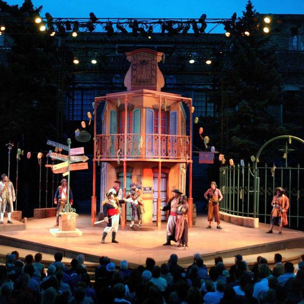 Shakespeare Festival stage with actors performing.