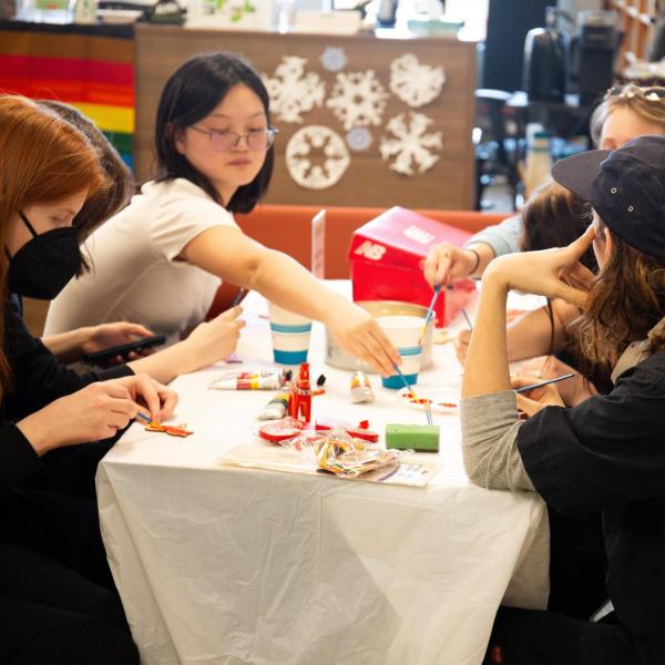 campus community members sitting at a table together