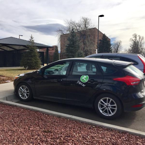 A Zipcar is parked on campus.