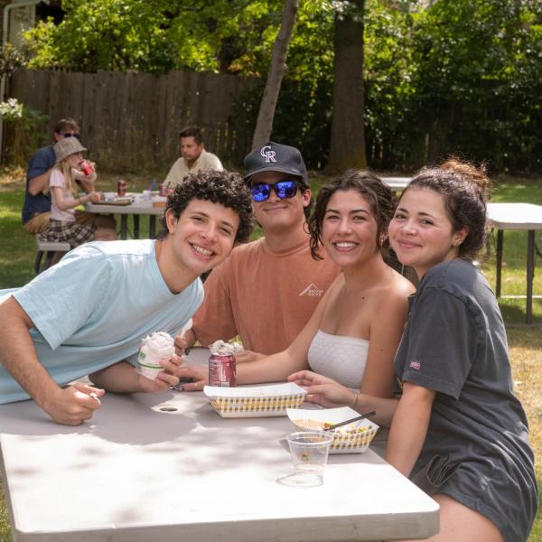 students pose for a photo at a CU in the Neighborhood block party
