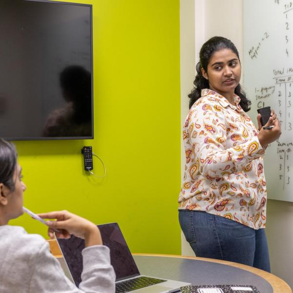 two students in a library study space