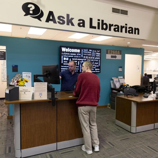 Student visits a librarian at the 'Ask a Librarian' desk