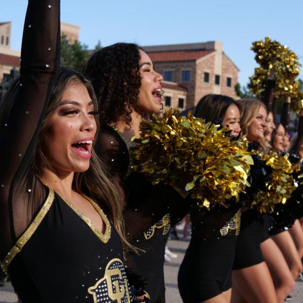 CU cheerleaders in black in gold