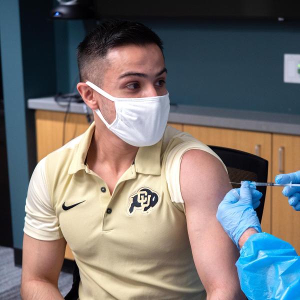 A student getting a vaccine