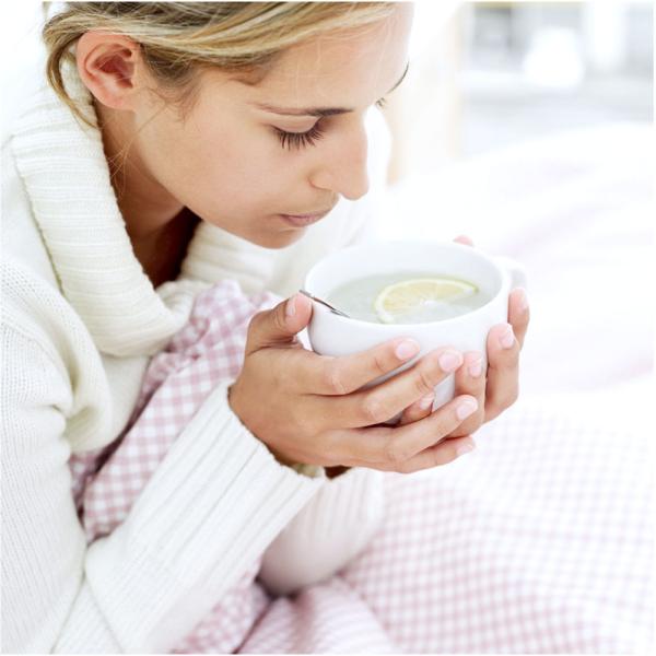 Woman holding cup of tea.