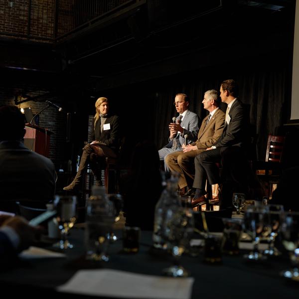 Panelists speak at a real estate event on campus