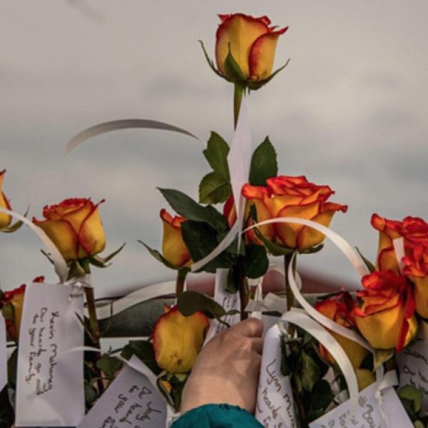 Photo of roses and notes at King Soopers memorial
