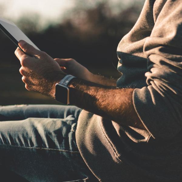person using tablet to speak with a mental health specialist via video call