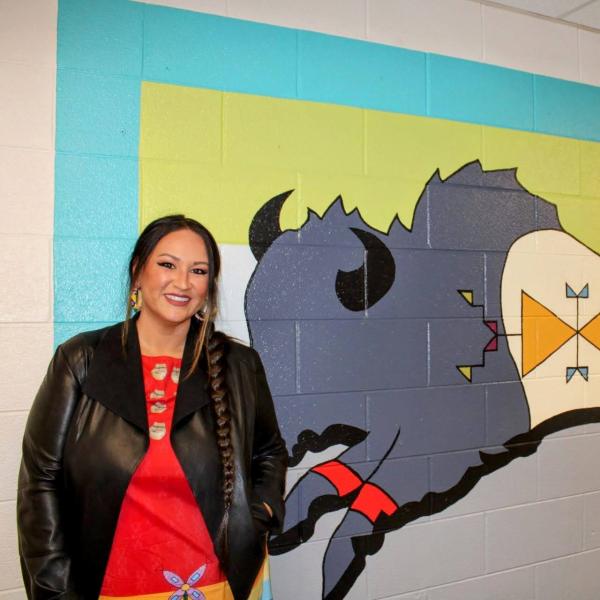 Danielle Seewalker in front of her buffalo mural in the Engineering Center
