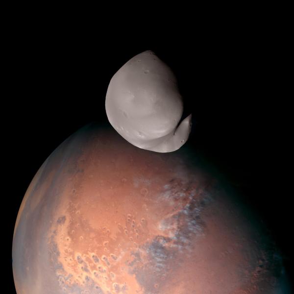 A striking view of Mars and its smallest moon, Deimos.
