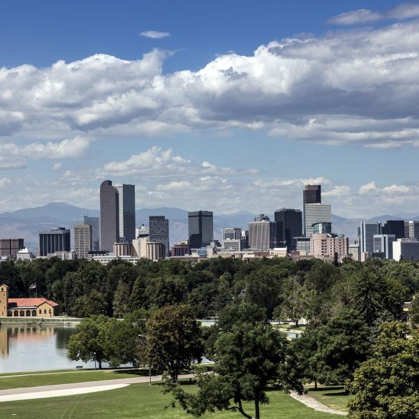A photo of downtown Denver in front of the Rocky Mountains.