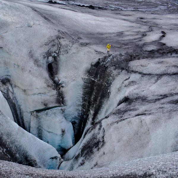 A person stands atop ice.