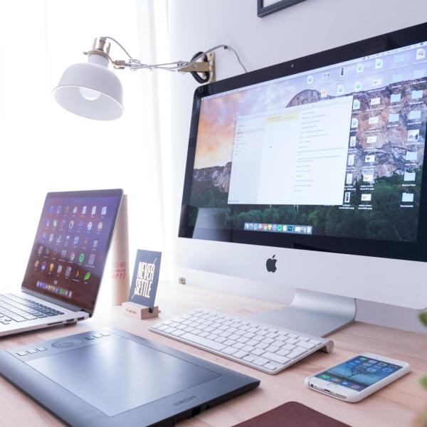 Laptop, desktop computer and phone on a desk