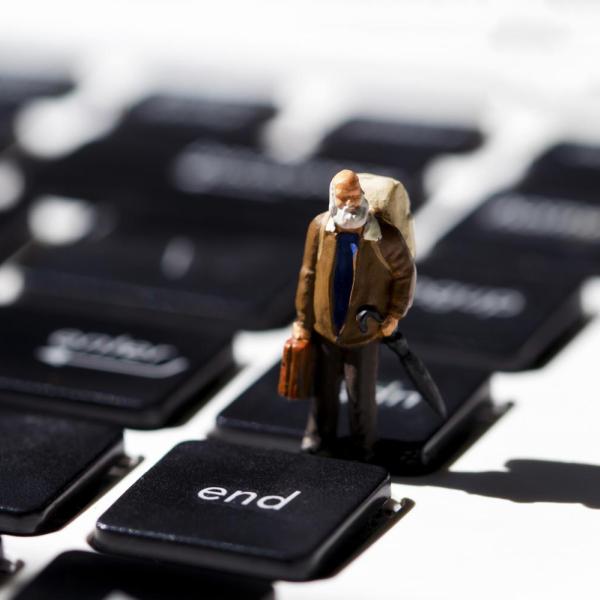 Image of a old man figurine on a keyboard