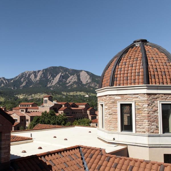 Tops of campus buildings with Flatirons in the background
