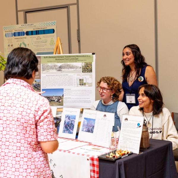 Campus community members visit a booth at the sustainability summit
