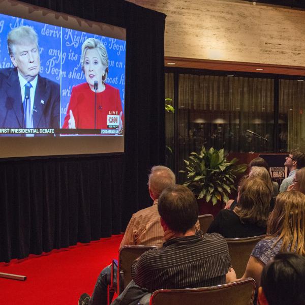 A crowd tunes in for a televised debate between Hillary Clinton and Donald Trump in 2016.