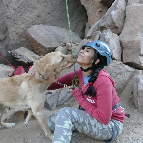 University of Colorado senior psychology major Esha Mehta gets some kisses from her seeing eye dog, Dragon, after rock climbing in Eldorado Canyon near Boulder. Mehta is a blind competitive rock climber.