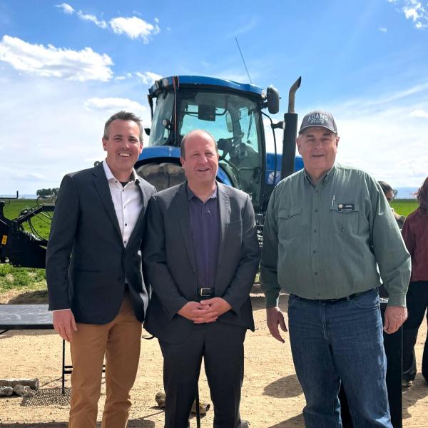Evan Thomas, director of the Mortenson Center; Gov. Jared Polis and Sen. Cleave Simpson in Alamosa, Colorado