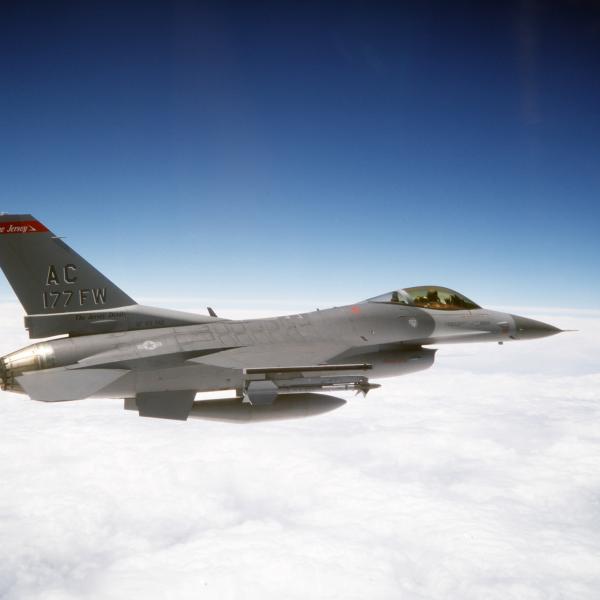 F-16C block 25 aircraft flying above the clouds