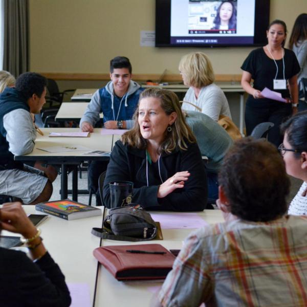 People converse at an event.