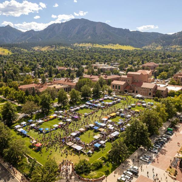 Tables and campus community members fill Farrand Field during the Be Involved Fair