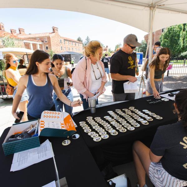 A Journey Leader tables at a Fall Welcome event