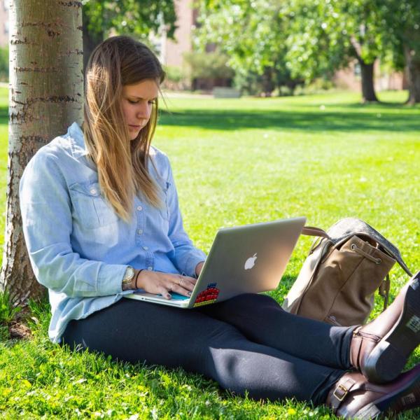 female studying outdoors on campus