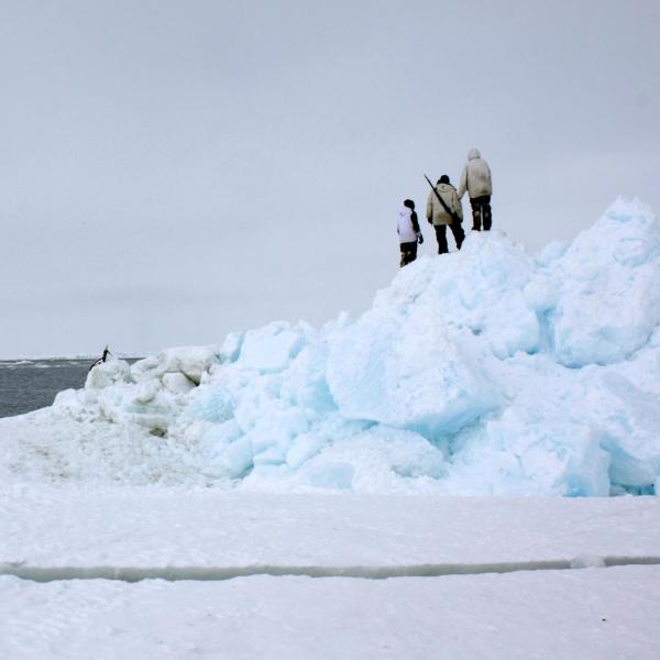 Community members from Utqiagvik, Alaska, look to open water from the edge of shorefast sea ice